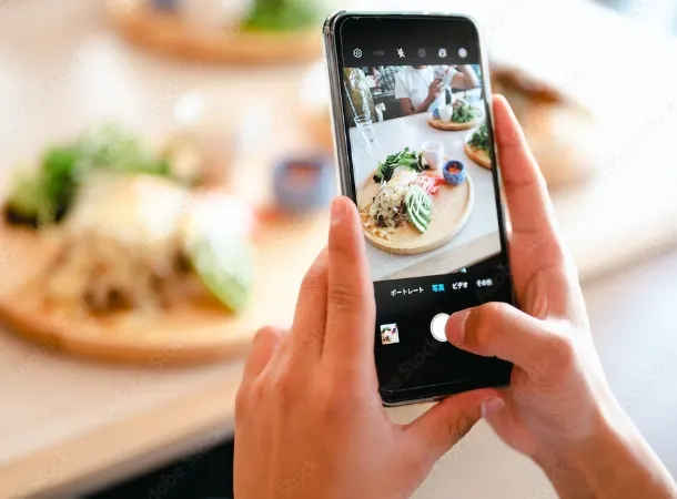 スマートフォンで料理を撮影している様子